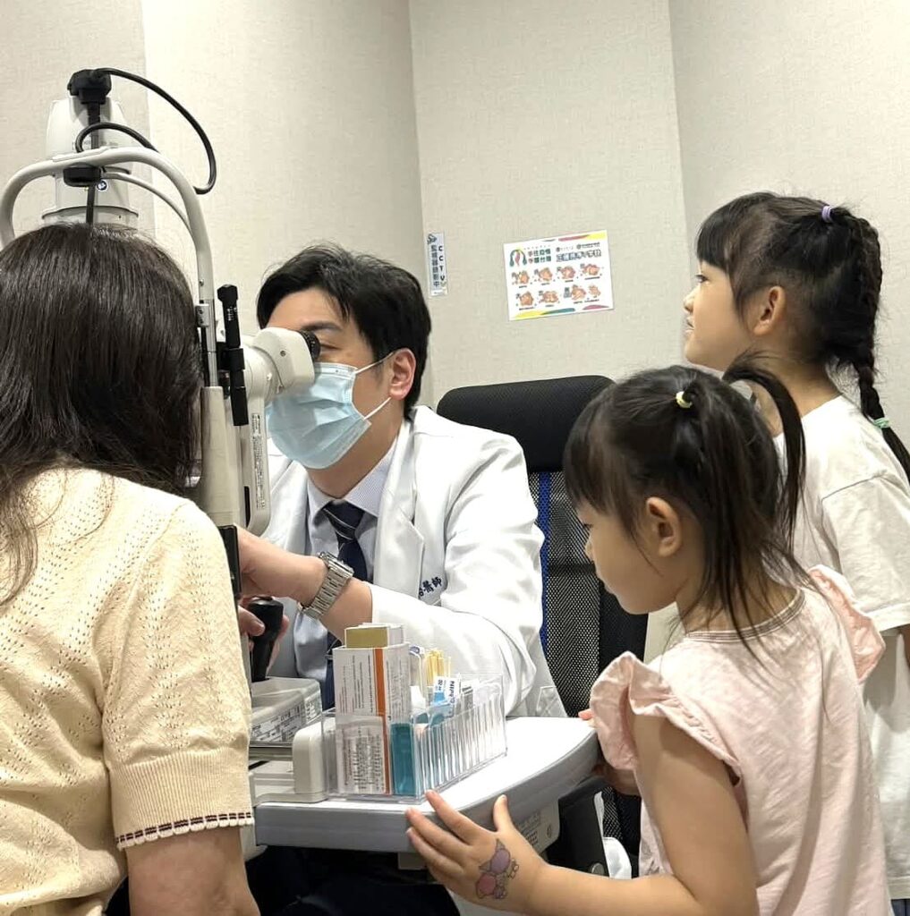 Dr. Chen performing eye exam for patients
